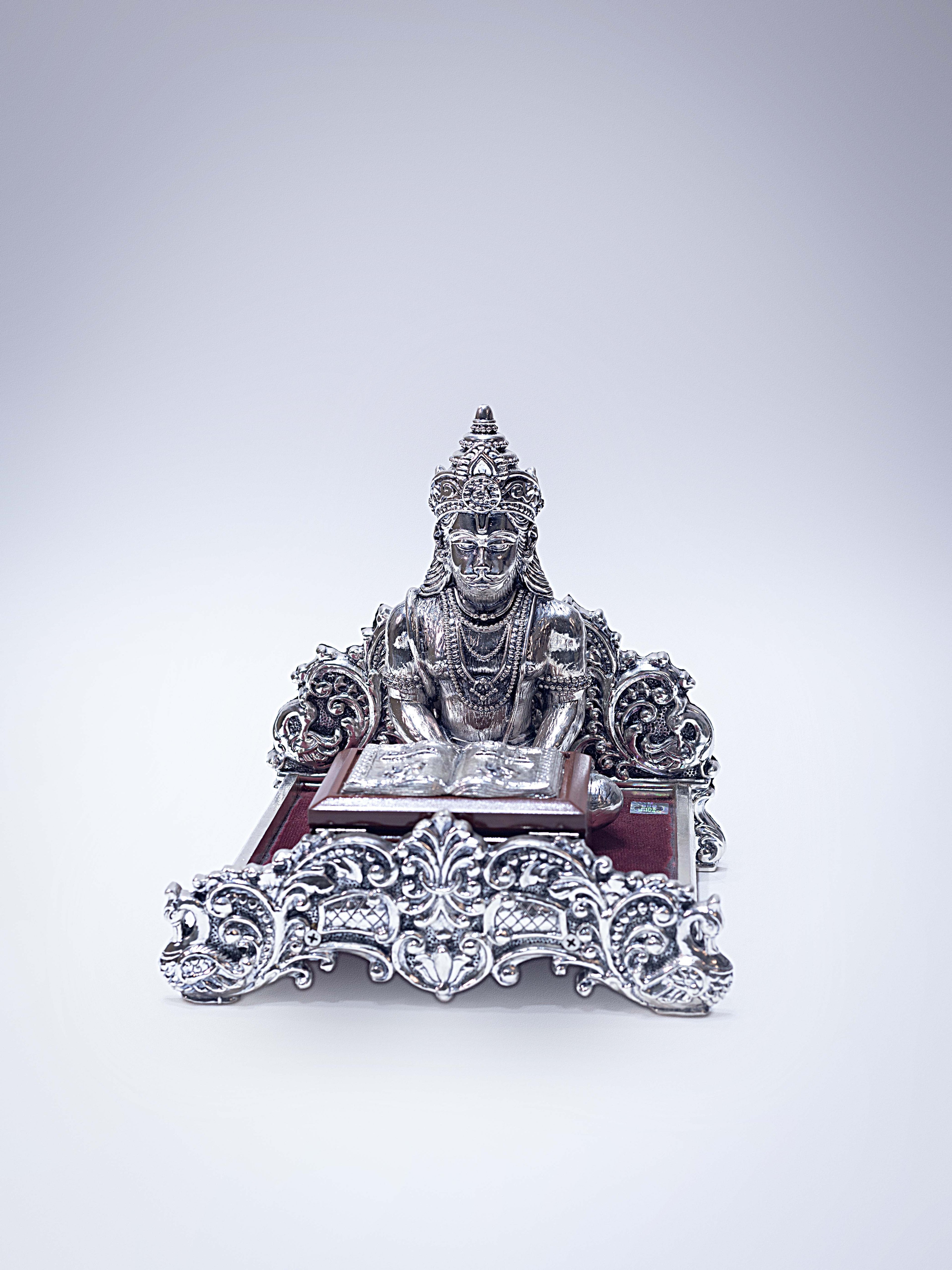 Silver Hanuman Ji Reading Geeta on a Wooden Base
