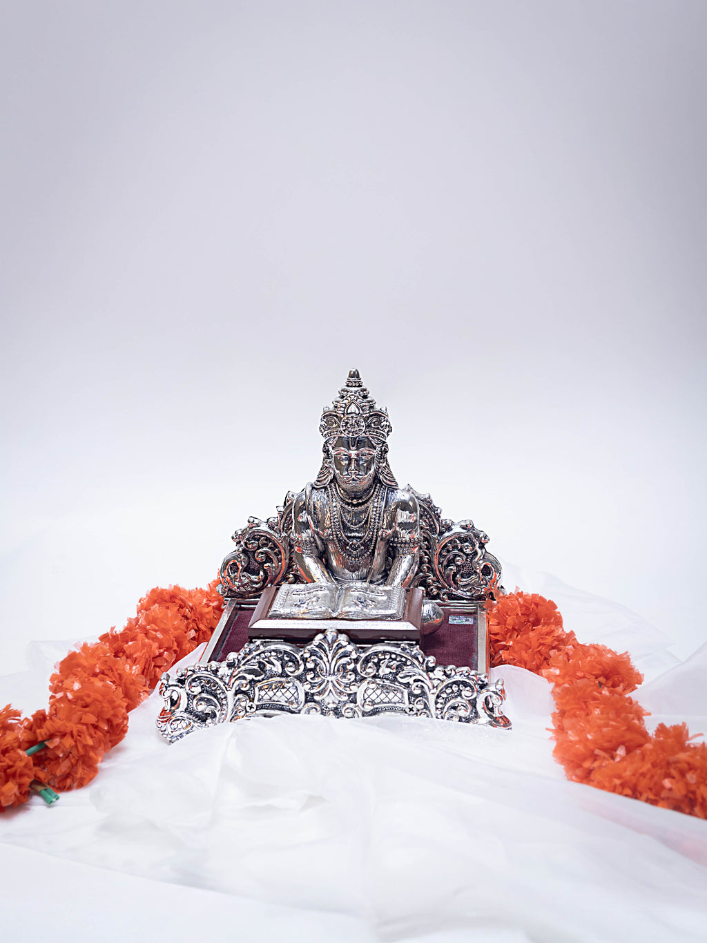 Silver Hanuman Ji Reading Geeta on a Wooden Base
