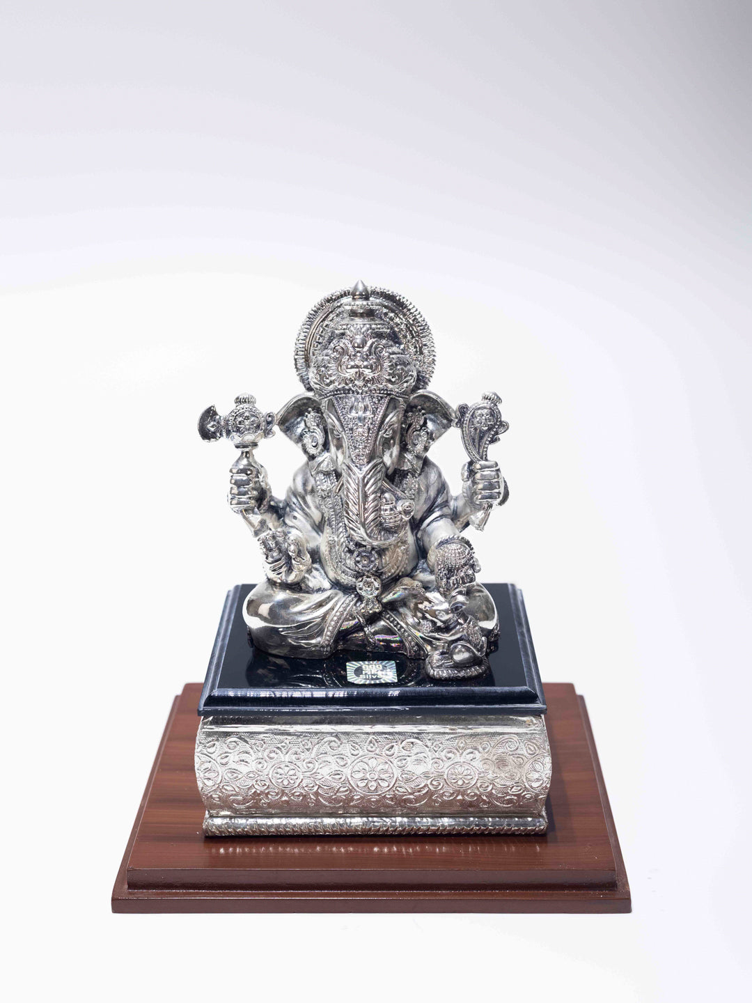 Silver Ganesh Ji Sitting on Black Marble
