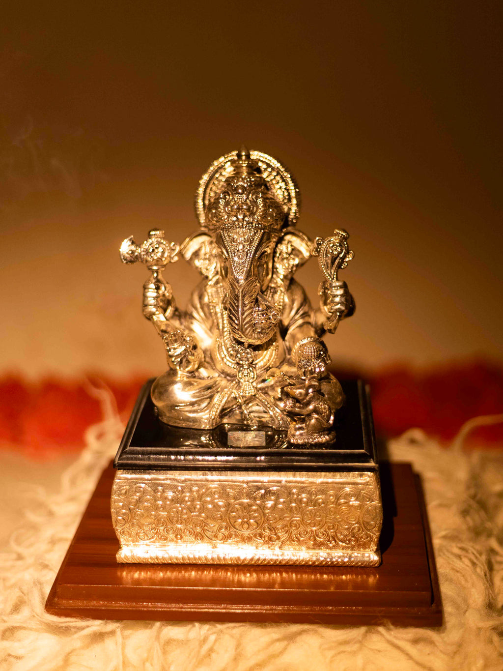 Silver Ganesh Ji Sitting on Black Marble