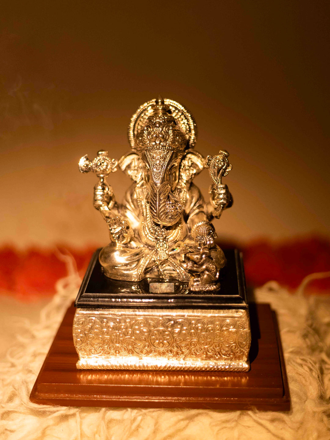 Silver Ganesh Ji Sitting on Black Marble